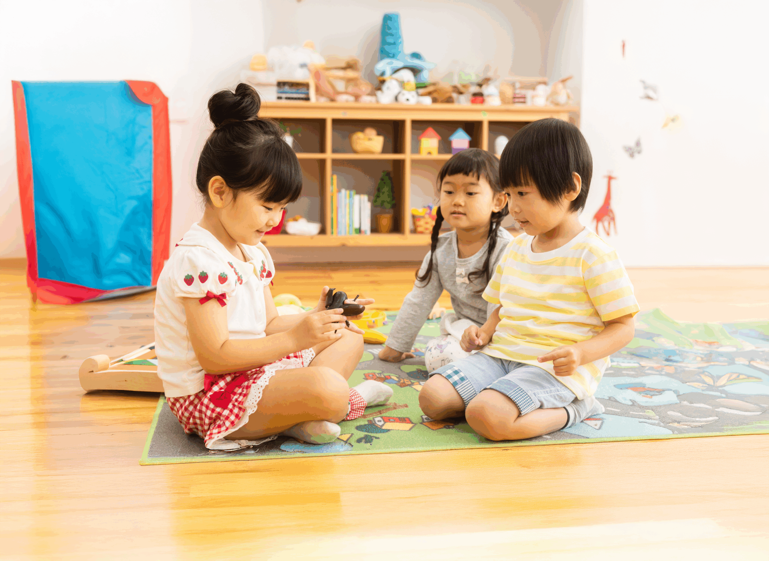 Bright modern room with white couch and wooden floor especially designed for kids area with safe furniture